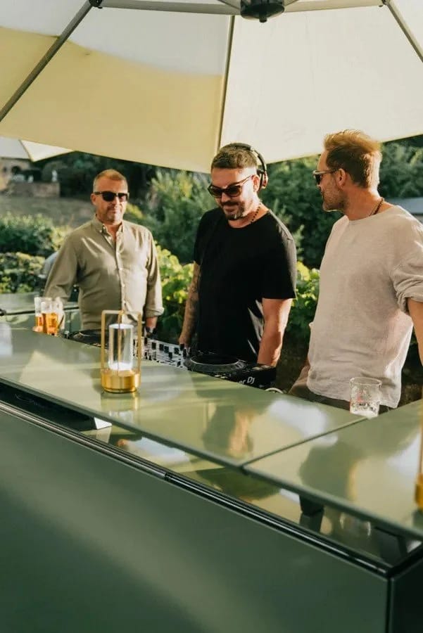 Guests gathered with drinks at the Vlaze outdoor kitchen counter