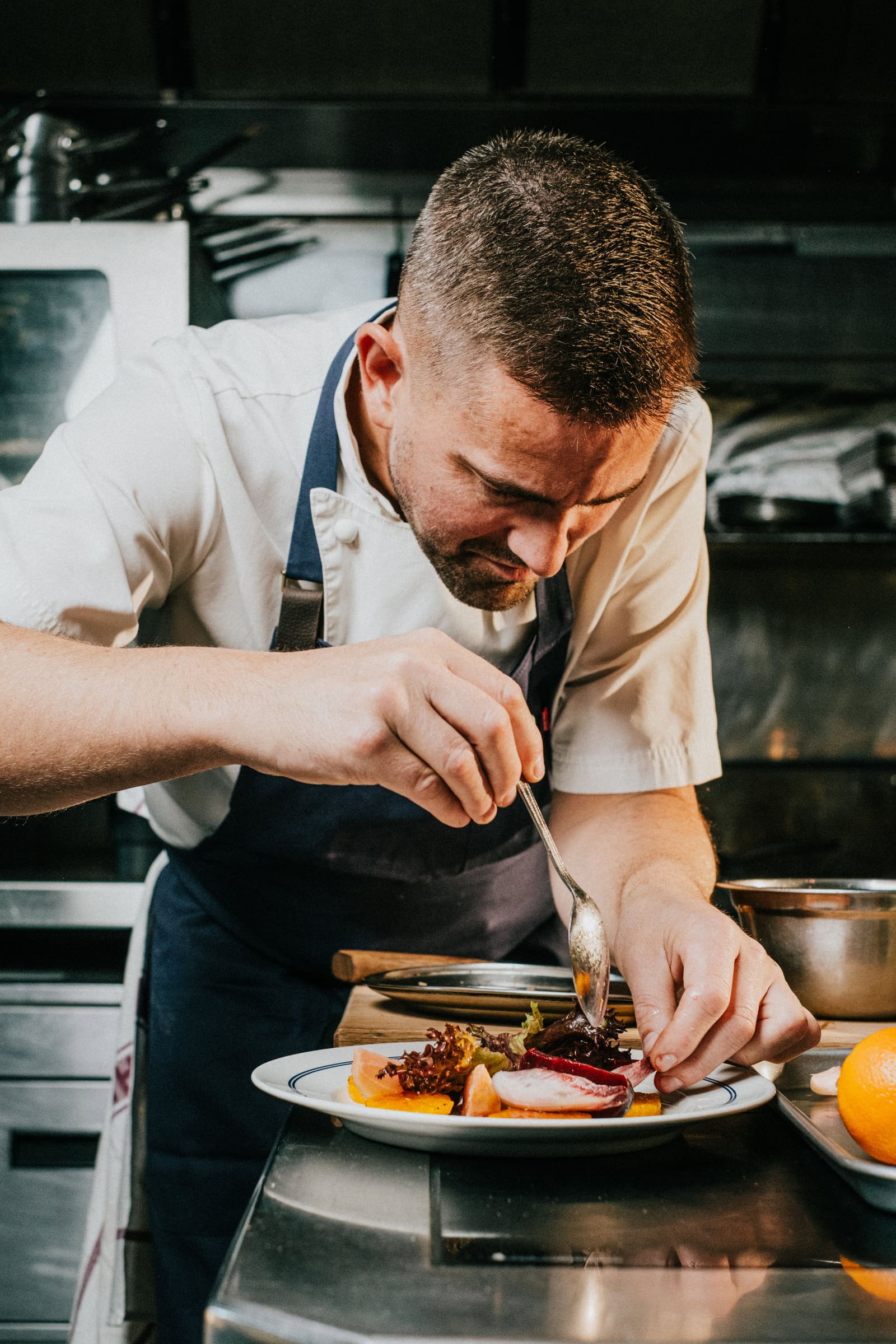 Robert finishing a plate of beetroot and orange with a spoon