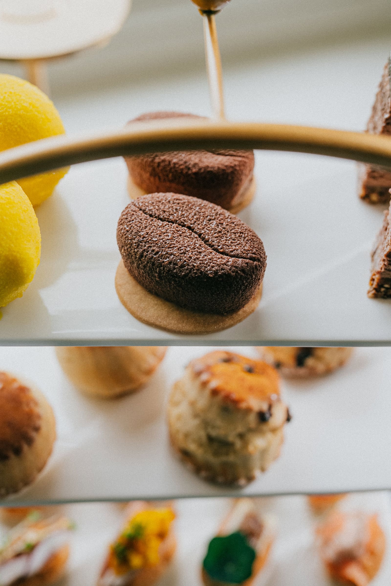 The top tier of the stand: lemons, chocolate pastries and a slice of cake