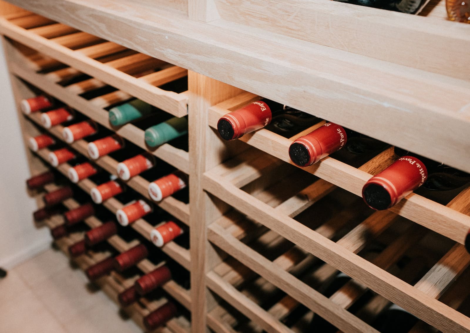 Bottles in the oak wine rack in The Cellar
