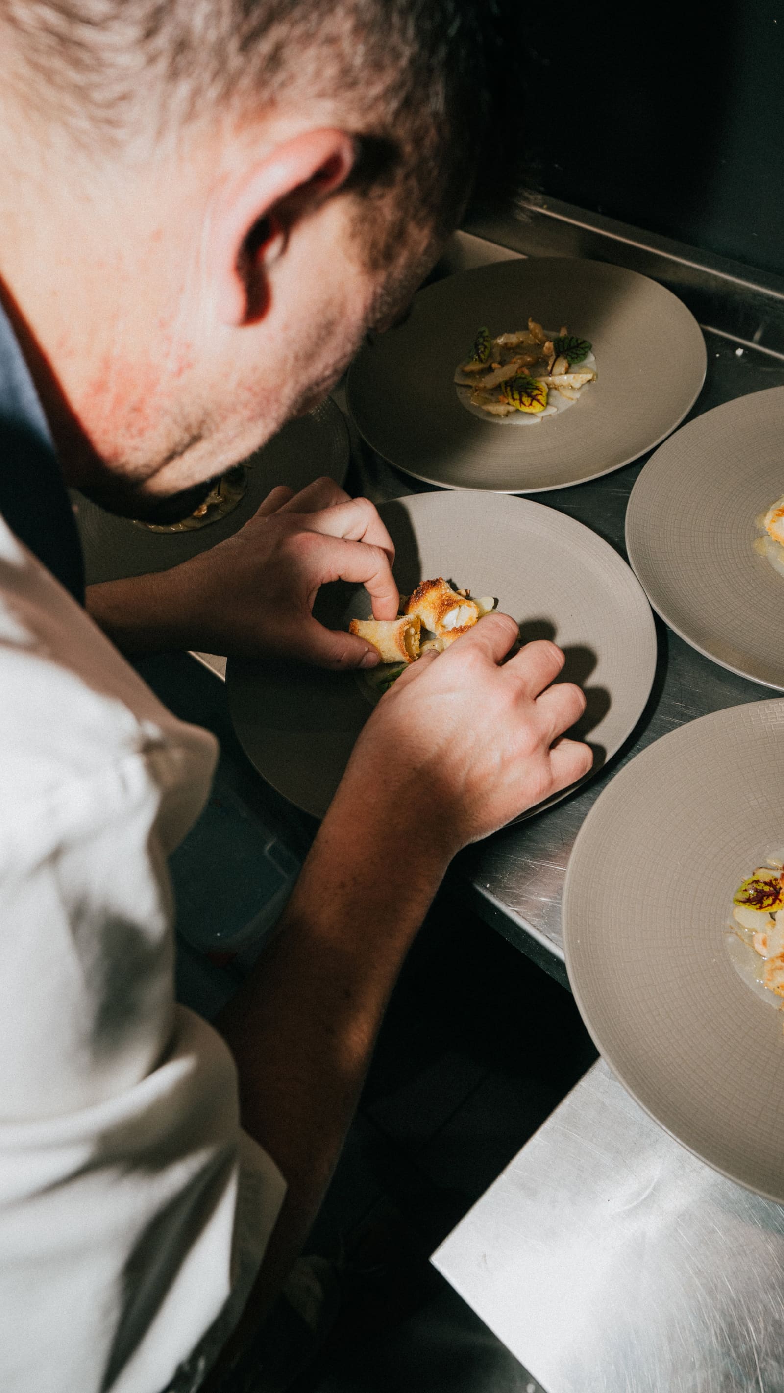 A chef plating at the pass