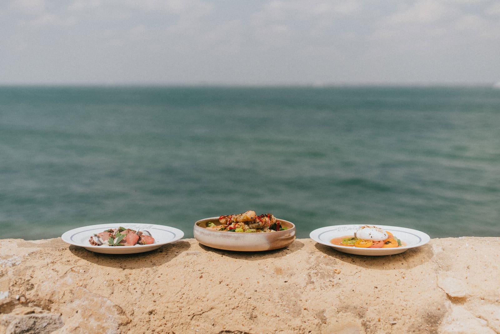 Three plates from the RT Café Grill kitchen on the sea wall, the Solent behind