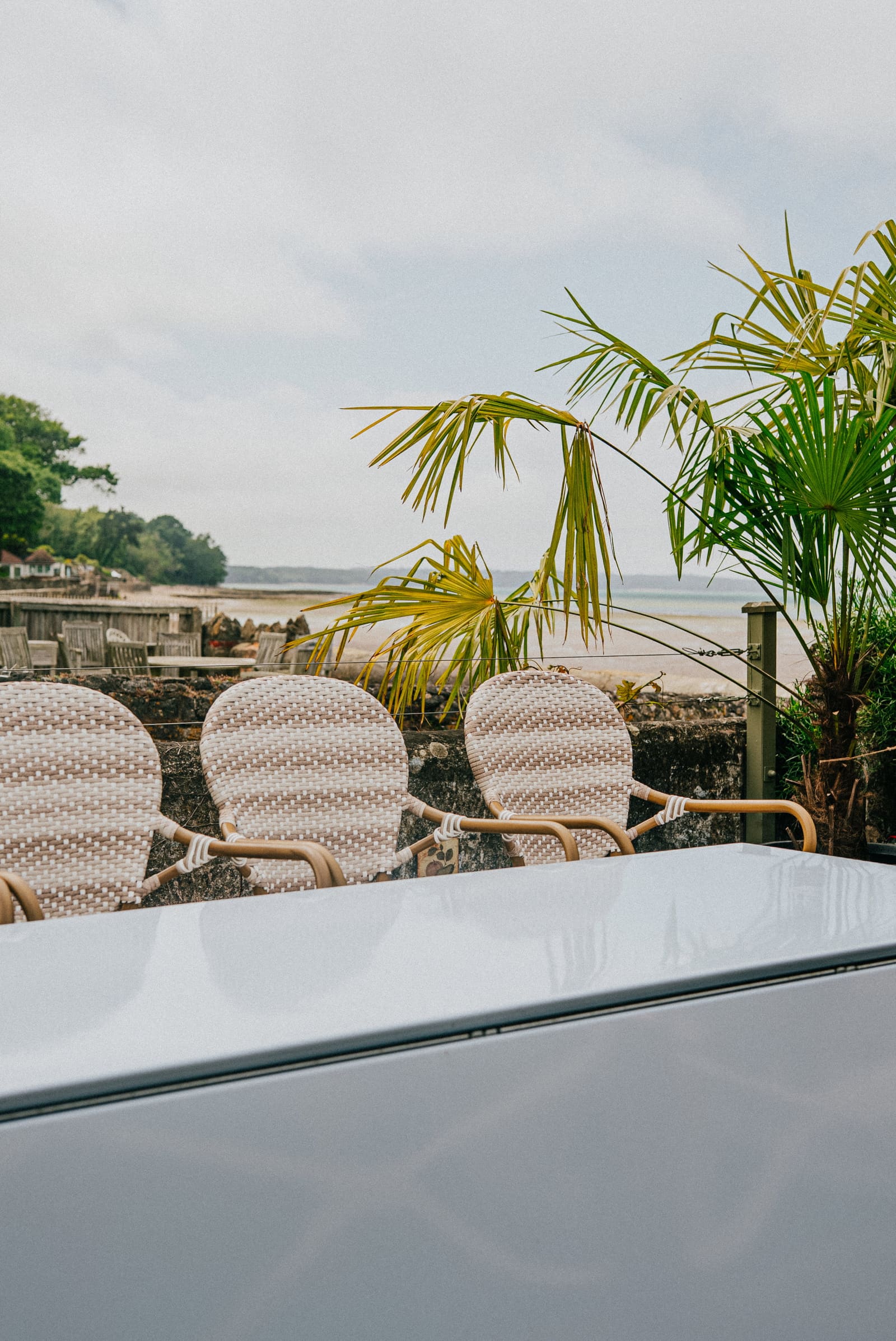 Rattan chairs on the terrace looking out over Ryde sands